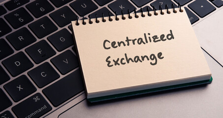 There is note book with the word Centralized Exchange on a laptop. It is an eye-catching image.