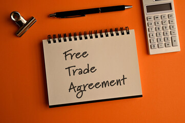 There is notebook with the word Free Trade Agreement. It is an eye-catching image.