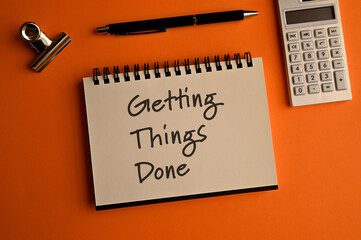 There is a notebook with the word Getting Things Done. It is eye-catching image.