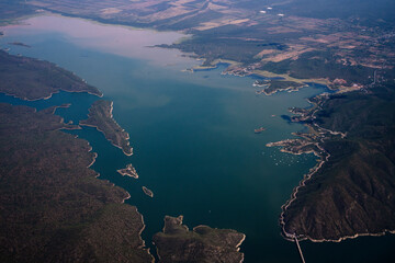 Geography. View of the blue river, bay coastline, and land seen from the sky. 