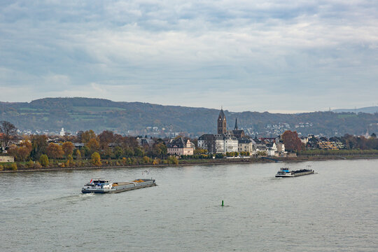 Two cargo ships on the river Rhine with the castle and the curch of Neuwied Engers in the background