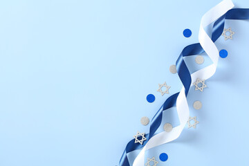 Festive Jewish decorations with blue and white ribbons on blue background. Banner design for Israel...