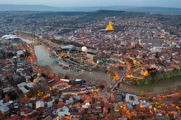 Picturesque general view from drone of Georgian city of Tbilisi on banks of Mtkvari River at spring...