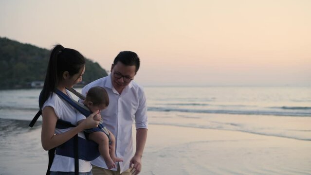 Tourism concepts of 4k Resolution. Asian family walking together by the beach.