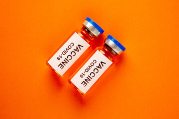 top view antivirus vaccine in little cans on orange background lab disease covid- isolation virus...