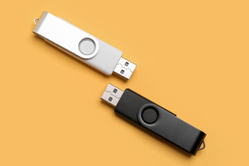 USB flash drives on yellow background