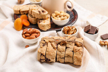 Tasty biscotti cookies and nuts on light fabric background