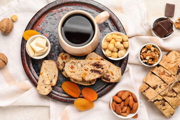 Composition with tasty biscotti cookies, cup of coffee, nuts and chocolate on light background