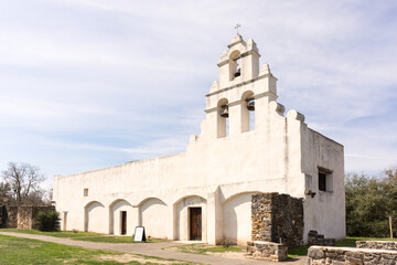 The pure white adobe of Mission San Juan bathed in sunlight, San Antonio, Texas, a UNESCO World Heritage Site. 
