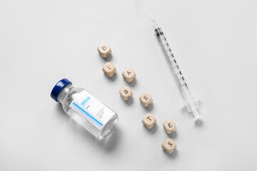 Word DIABETES with insulin and syringe on grey background