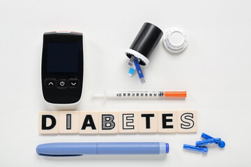 Word DIABETES with medical supplies on beige background