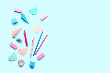 School stationery with paper hearts on blue background. Children's Day celebration