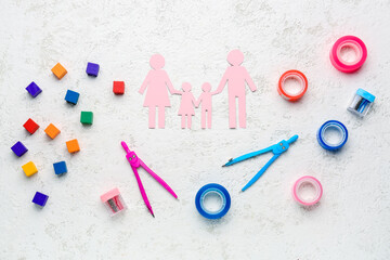 Family figure with school stationery and toys on grunge background. Children's Day celebration