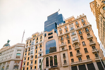 Historic old buildings in the shopping street Gran Via in Madrid before sunset
