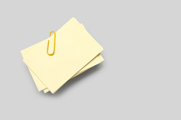 Paper sheets with clip on grey background