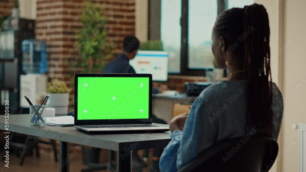 Poster manager working with greenscreen in business office, looking at blank chroma key display. company em
