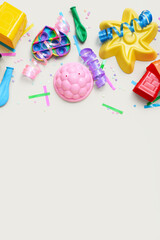 Baby toys with confetti and balloons on beige background. Children's Day celebration