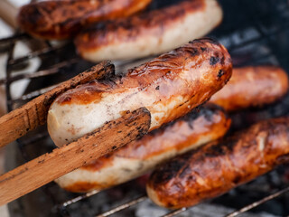 Original German Bratwurst sausage sizzling on the grill