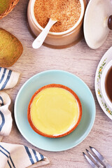 Lemon tart on a plate with hot tea