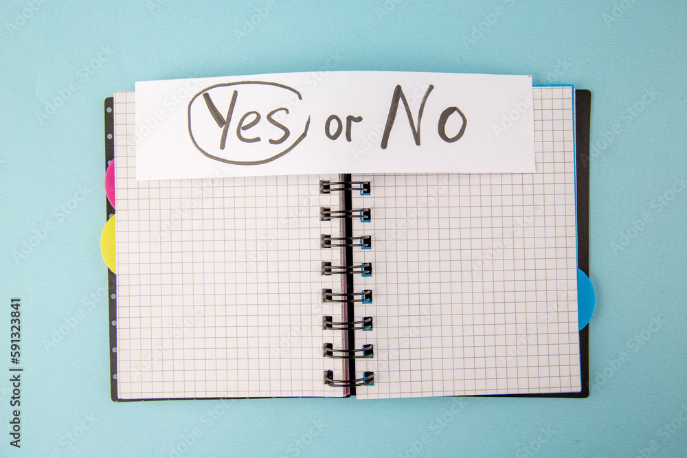 Wall mural top view open copybook with yes or no note on a blue background color notepad school lessons study s