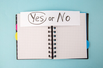 top view open copybook with yes or no note on a blue background color notepad school lessons study student college