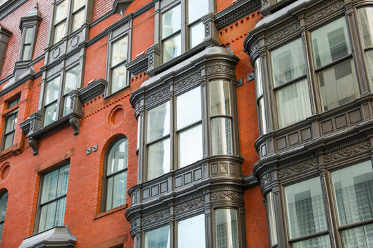 city brick buildings can symbolize urbanization, industrialization, and modernity, representing stability and endurance, while the cityscape suggests a bustling and dynamic environment