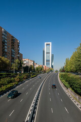 Fototapeta na wymiar Road at Financial business district in Madrid with Cuatro Torres towers area, spain