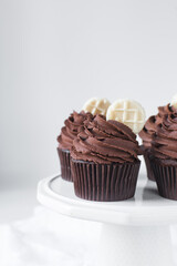 Chocolate cupcake with dark chocolate buttercream, double chocolate cupcakes with american buttercream, tall swirl frosting on a cupcake with a wafer