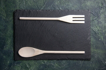 top view plastic utencils with black board on dark background food spoon knife photo plastic dinner kitchen fork