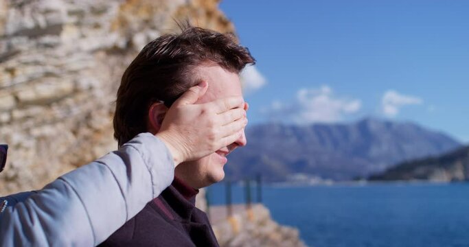 Profile of man against the backdrop of colorful landscape of mountains, sea, upset, going through a lonely date, being late, joy. Newlyweds man in love quarrel relationship emotions. Holiday romance