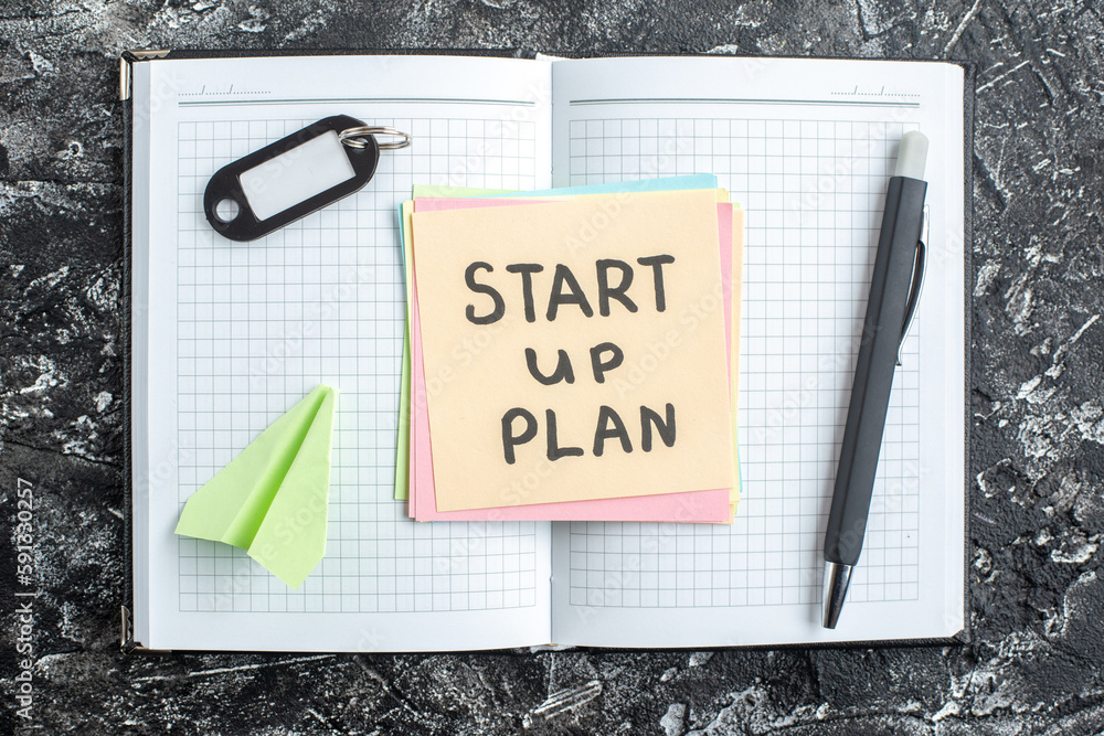 Wall mural top view start up plan note on sticker with copybook on gray background lesson student notepad note 
