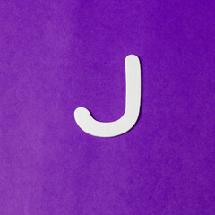 Letter J in wood texture - Purple background