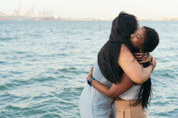 Fototapeta na wymiar two women embracing in a city park. Concept of friendship