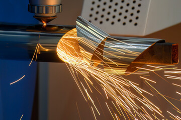 Close up scene the fiber laser cutting machine cutting  machine cut the stainless steel tube.