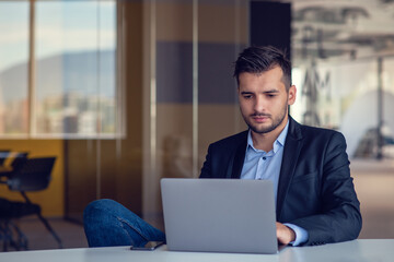 Portrait of worried young man at workplace. Stress concept