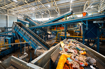 Conveyor carries trash pieces in recycling plant workshop - 591337002