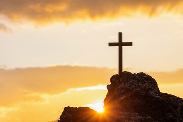 Silhouettes of crucifix symbol on top mountain with bright sunbeam on the colorful sky background