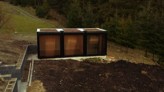 Tiny house transported and being built on site; low angle drone tracking