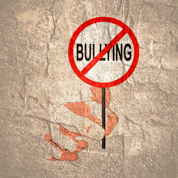 Hand Holding Stop Bullying Road Sign. Stop Bullying and Child Abuse in the School. Verbal, Social, Physical and Cyberbullying concept.