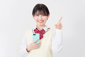 スマホを持って右側を指差す女子高生　白背景