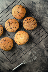 Homemade chocolate chip cookies on black baking cooling tray and abstract background