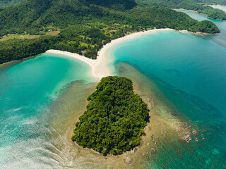 Island with sandy beach and turquoise water. Kelambu Beach. Borneo, Malaysia.