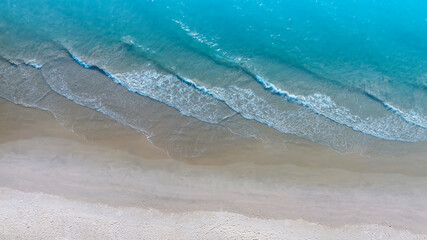 Aerial view with beach in wave of turquoise sea water shot, Top view of beautiful white sand background