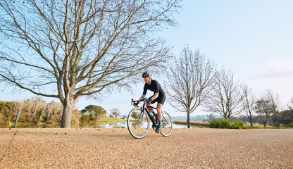Sports, bicycle and woman cycling in a forest for fitness, exercise and morning cardio in nature....
