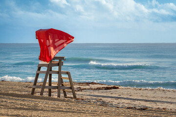 empty lifeguard station with red awning facing the sea on an empty beach in Cancun next to the Hotel Zone (Zona Hotelera). November 21, 2022 - Cancun, Mexico. - obrazy, fototapety, plakaty