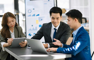 Image of business partners discussing documents and ideas with new startup project in office.  .