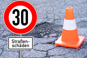 Schild Geschwindigkeitsbegrenzung 30 und Hinweis auf Straßenschäden