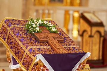 Orthodox life-giving cross with the image of Jesus Christ on the table in the church. Orthodox faith. Easter holiday. Prayer to God