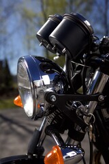 close up of a motorcycle headlight and front - from a side view