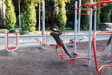 young woman doing sports on outdoor sports ground in summer